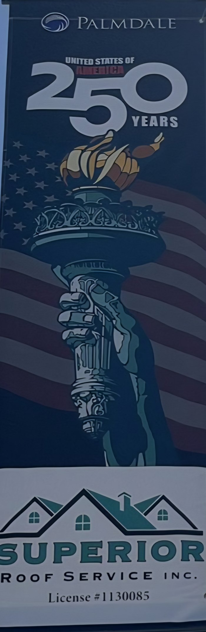 Palmdale America 250 banner with the Statue of Liberty torch and the Superior Roof Service logo